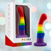 The Avant P1 Silicone Pride Freedom Dildo by Avant, made from platinum-cured silicone with a curved tip, sits beside its "PRIDE" box, framed by soft rainbow bokeh lights for a vibrant, celebratory display.